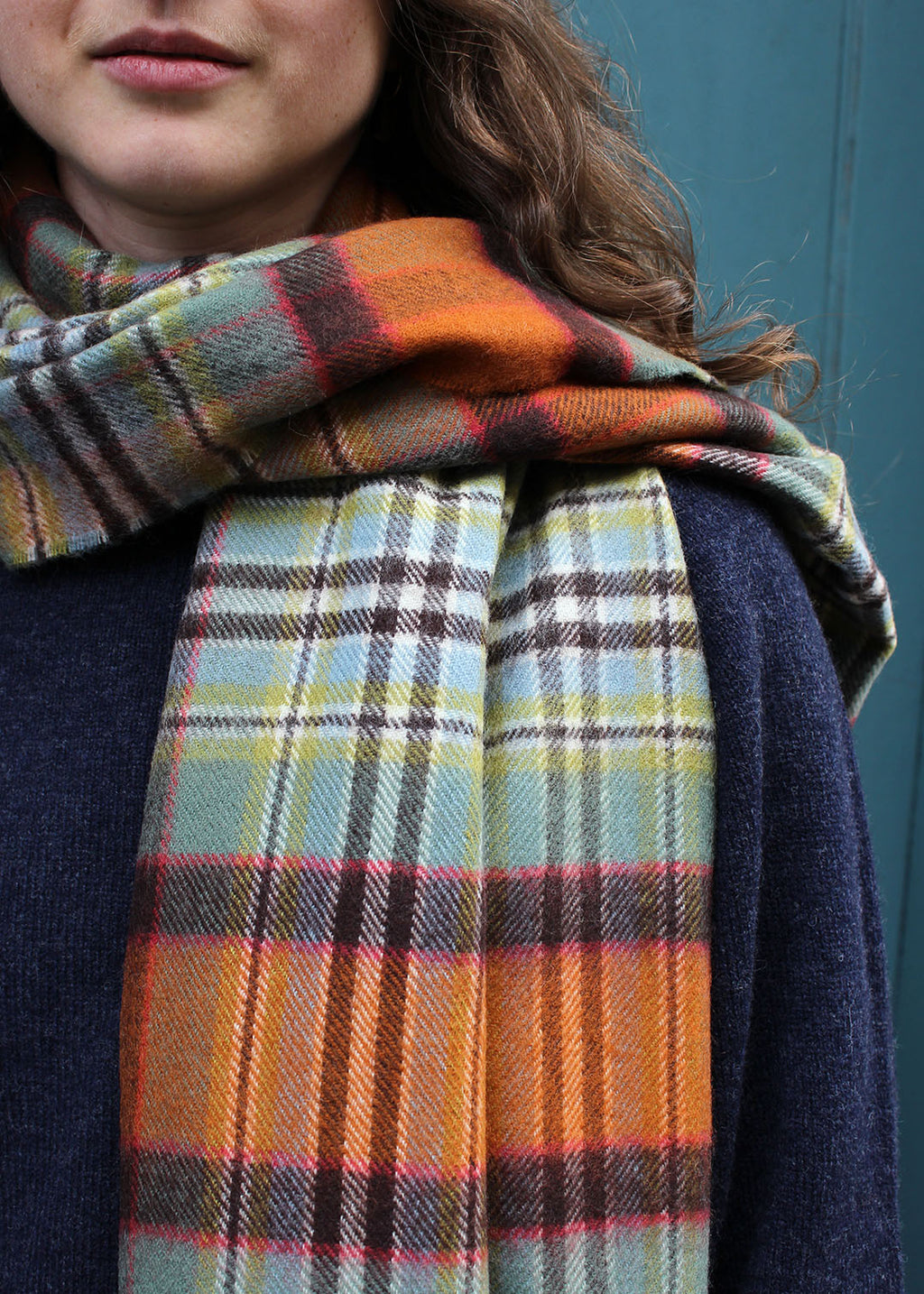 Lambswool tartan scarf in Dundee Old Weathered tartan shown on model.