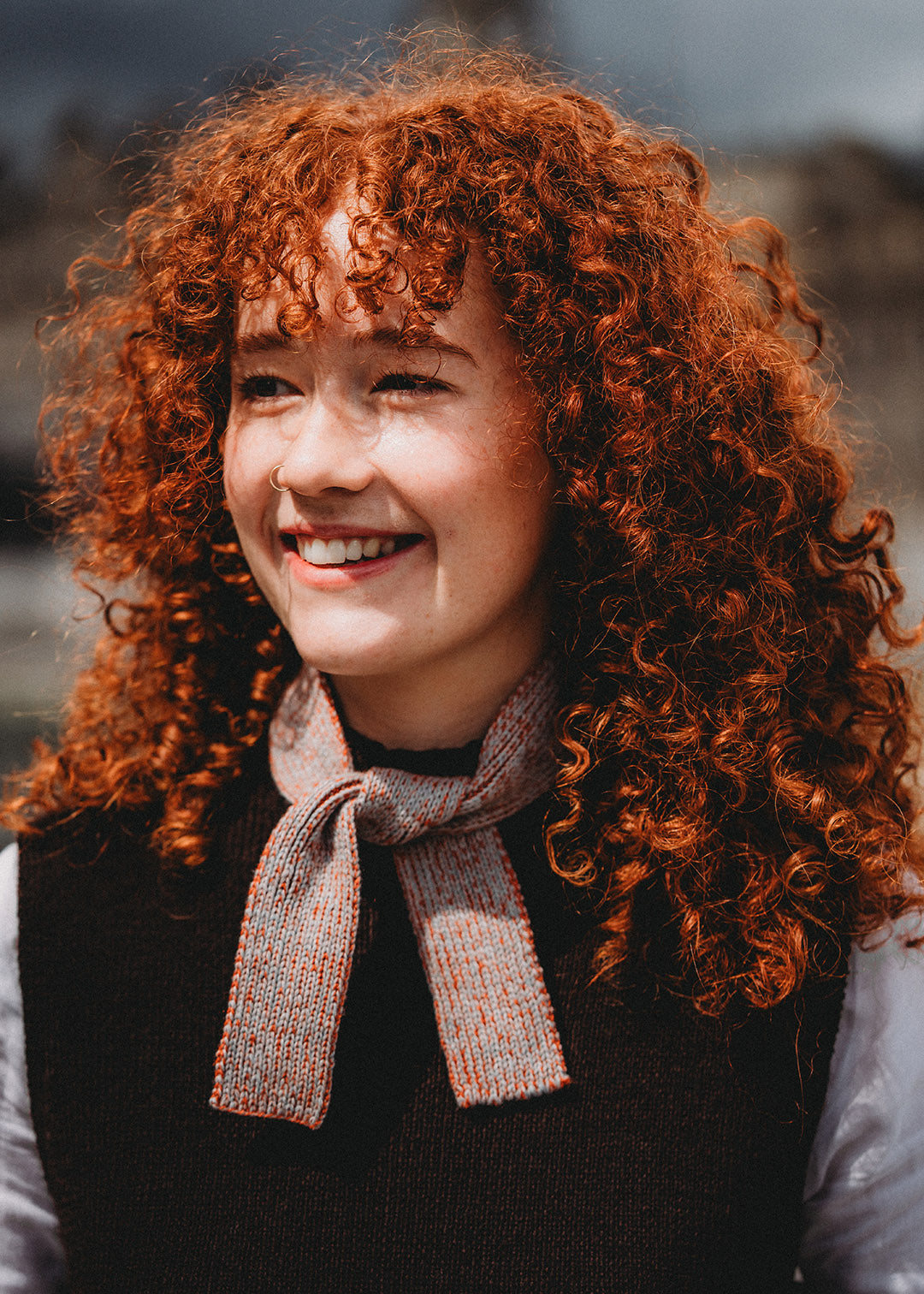 Add a pop of colour to your outfit with a mini tie scarf, knitted in a blend of natural fibres.