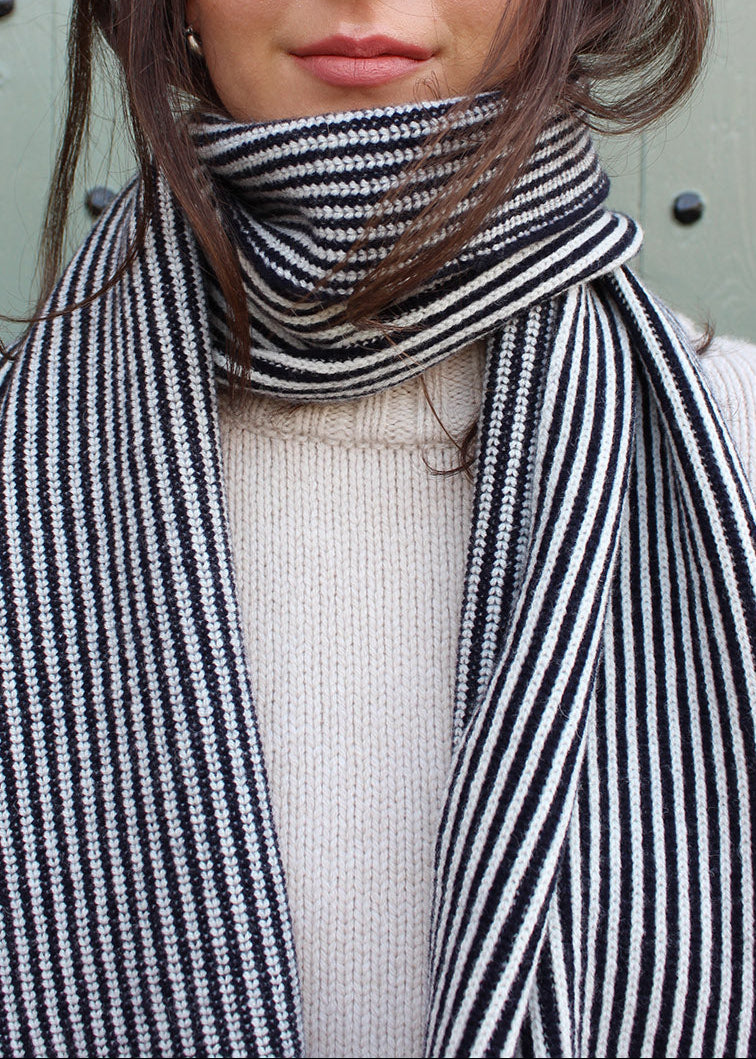 Lambswool black and white striped scarf shown on model. Scottish Textiles Showcase.