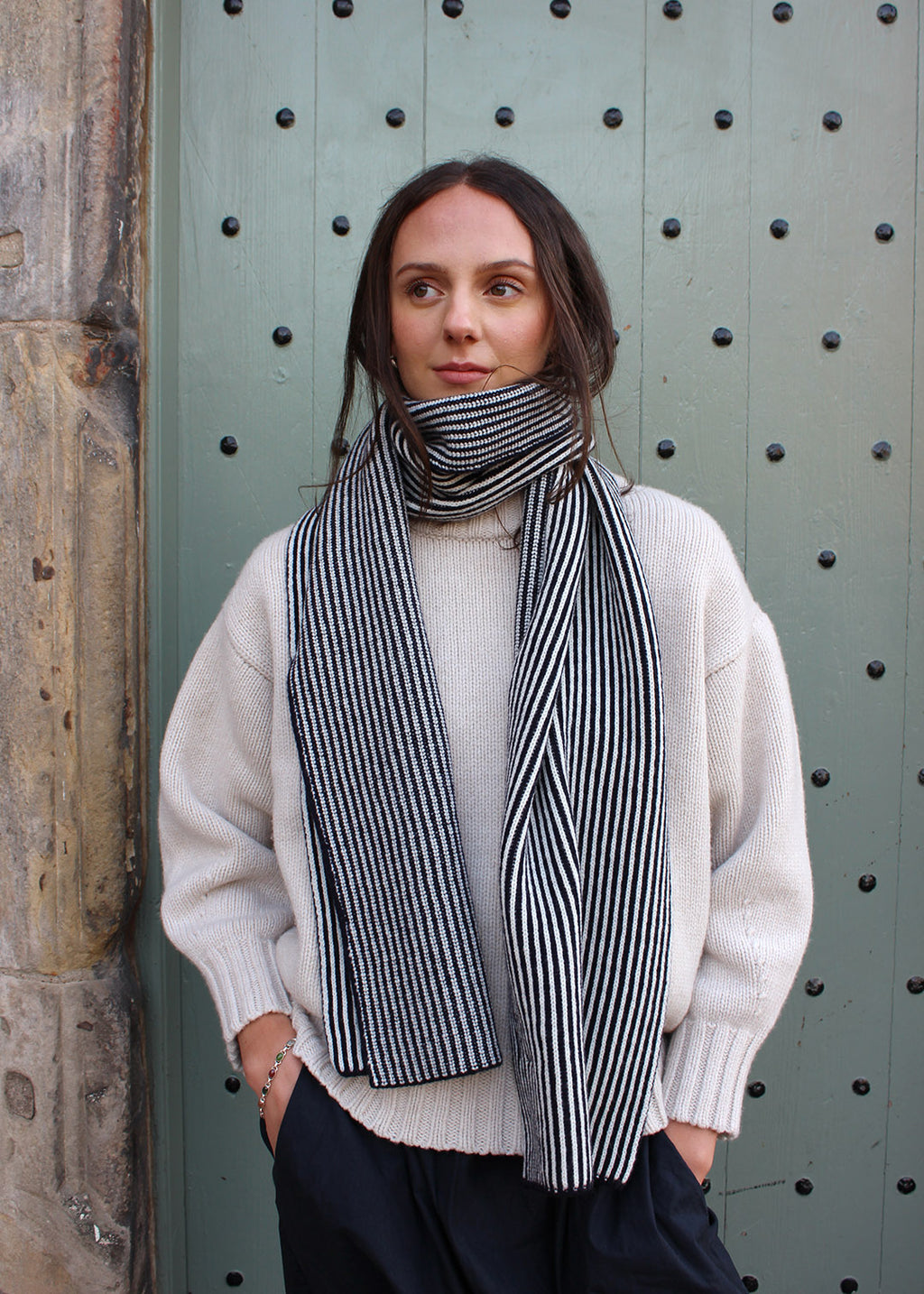 Lambswool black and white striped scarf shown on model. Scottish Textiles Showcase.