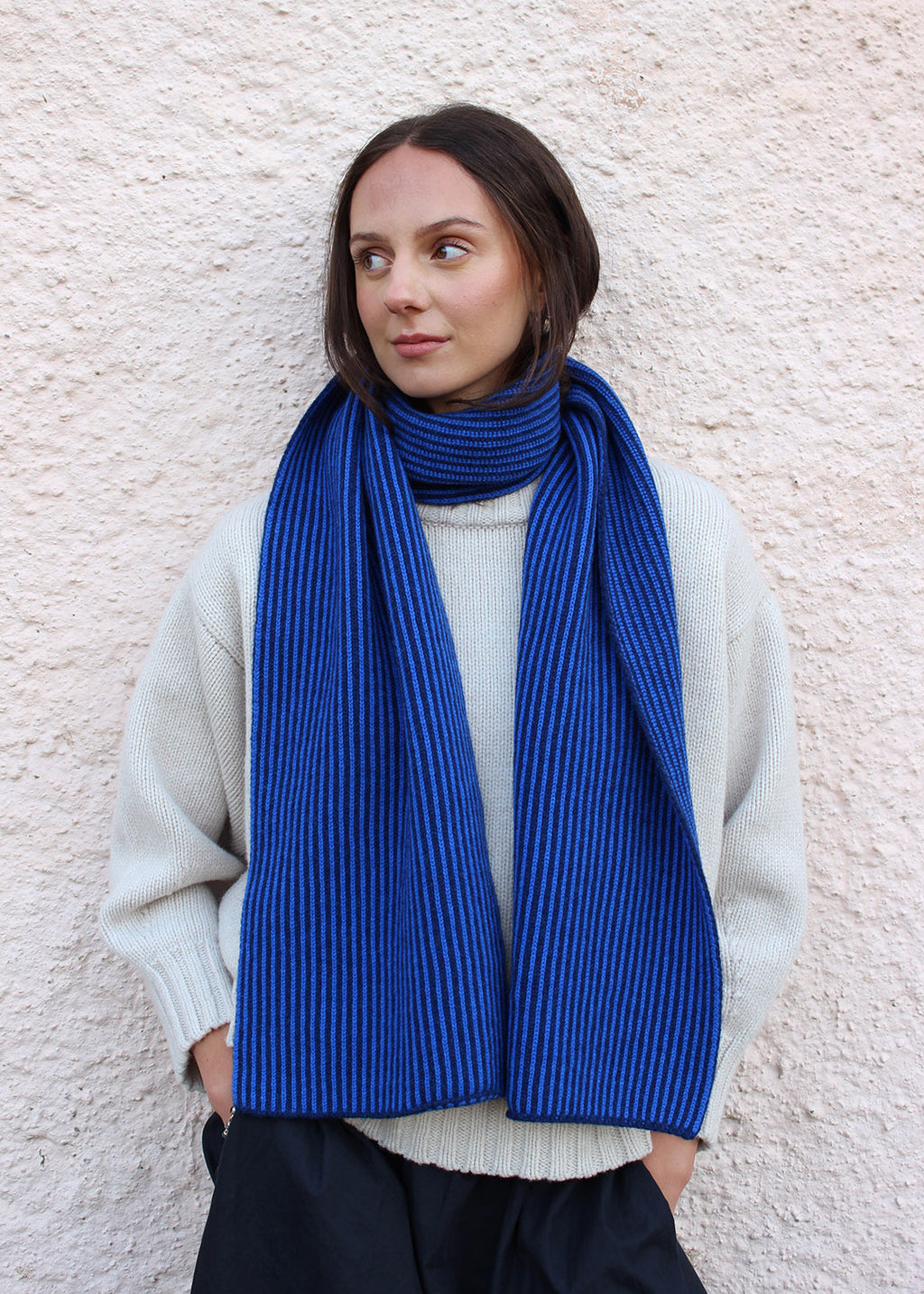Lambswool cobalt blue and navy striped scarf shown on model. Scottish Textiles Showcase.