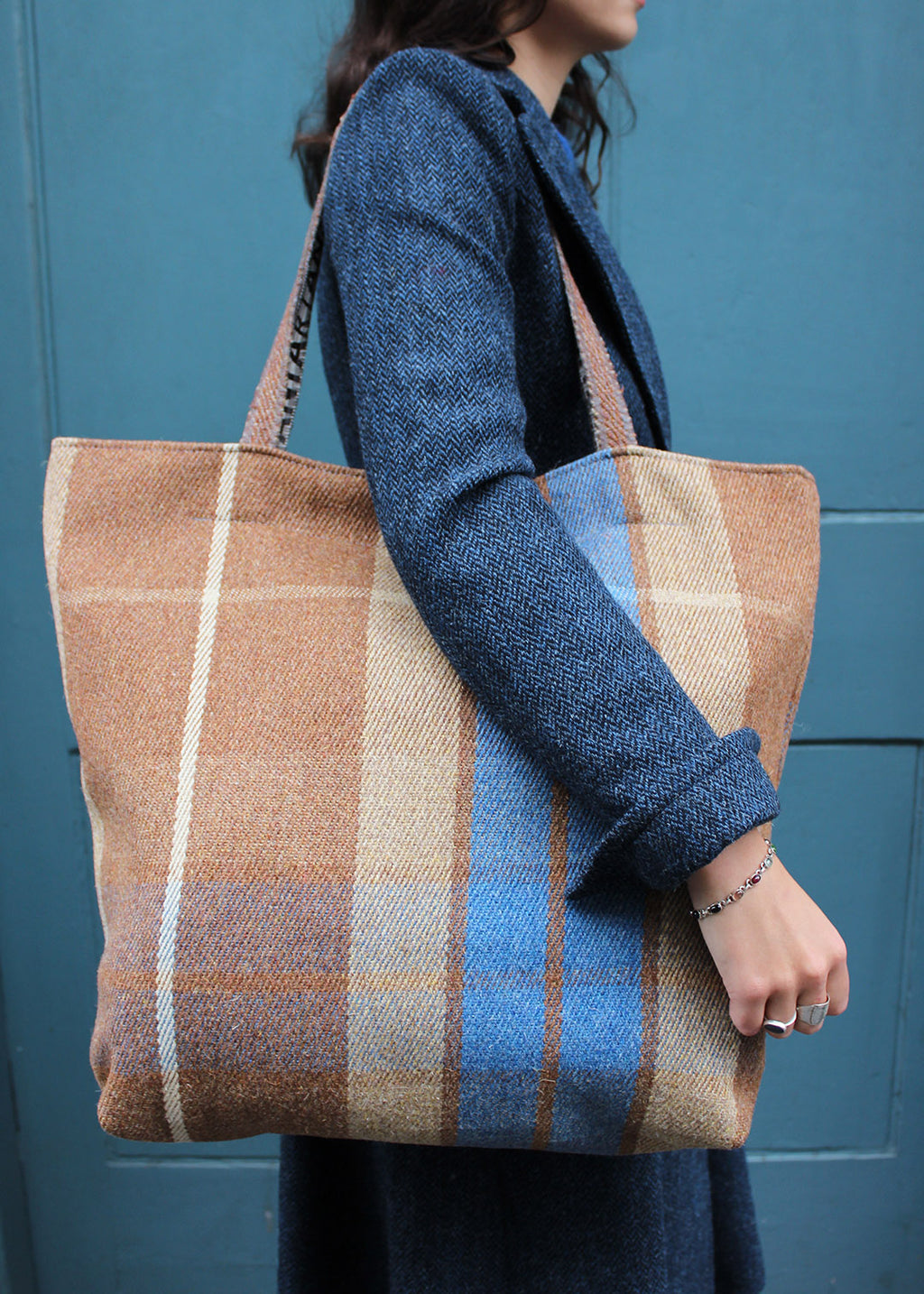 Wool travel bag shown on model. Scottish Textiles Showcase.