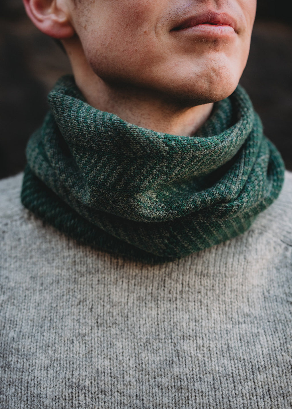 Lambswool knitted neck warmer shown on model.