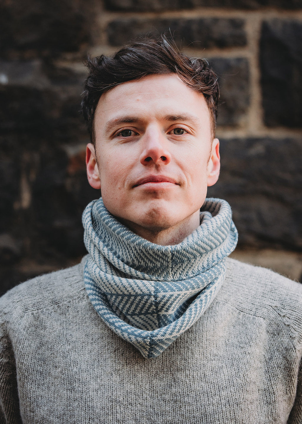 Lambswool knitted neck warmer shown on model.