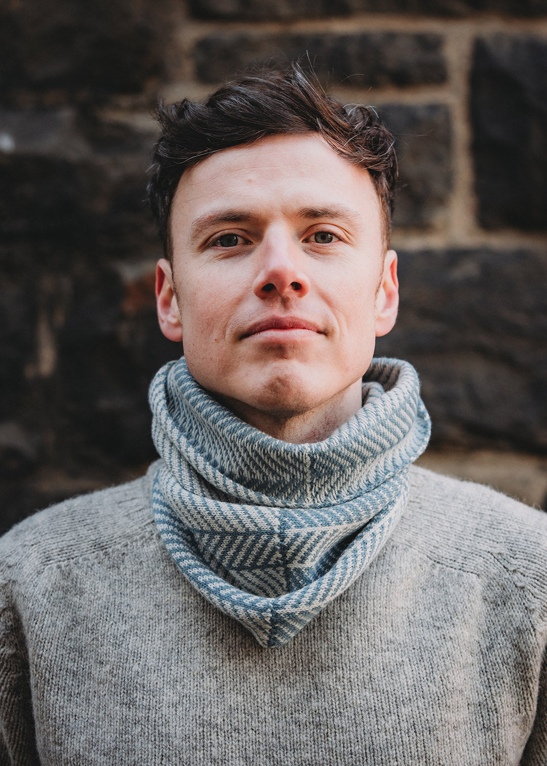 Lambswool knitted neck warmer shown on model.