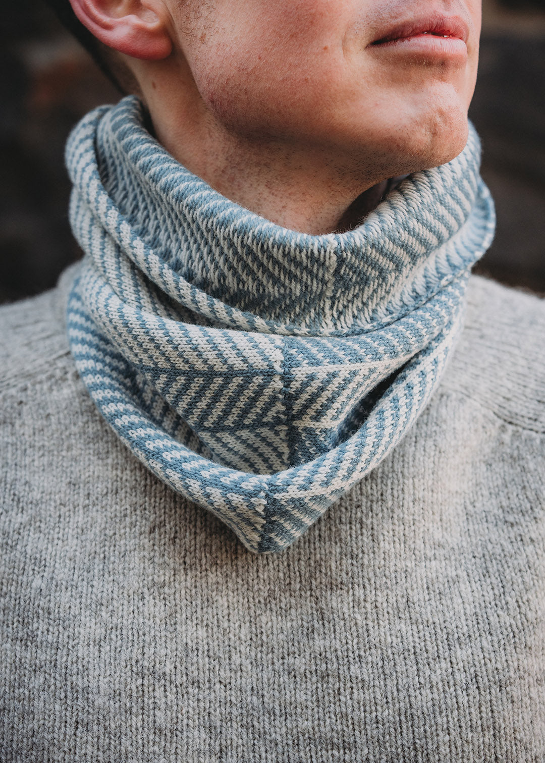 Lambswool knitted neck warmer shown on model.