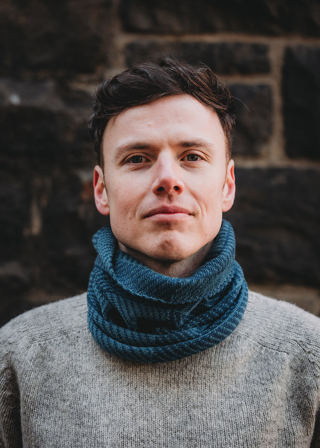 Lambswool knitted neck warmer shown on model.