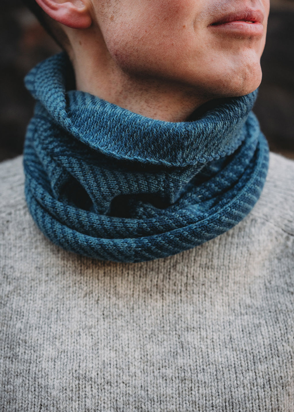 Lambswool knitted neck warmer shown on model.