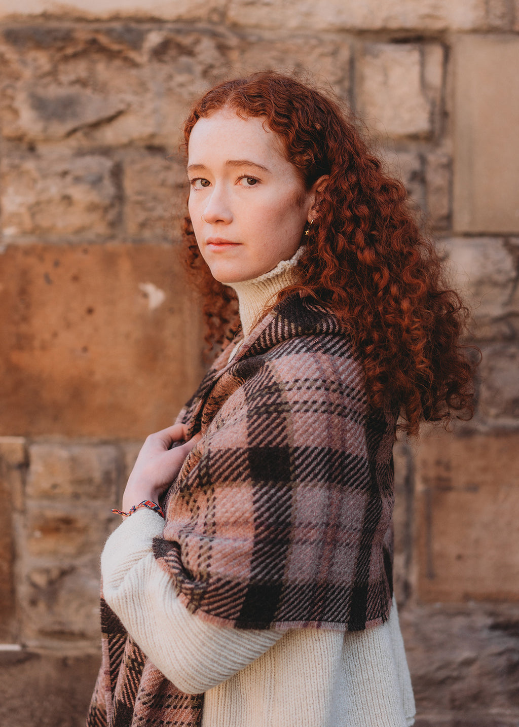Classic checked scarf woven with 100% British wool in shades of pink and brown.