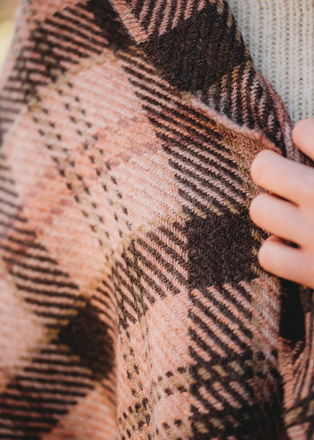 Classic checked scarf woven with 100% British wool in shades of pink and brown.