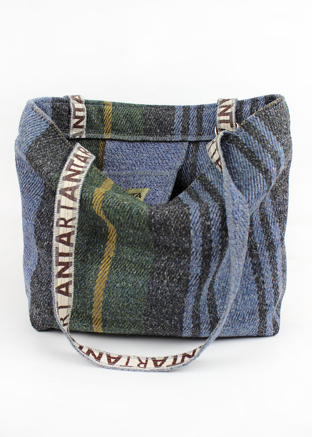 Wool carpet bag woven in green, blue, black and yellow.