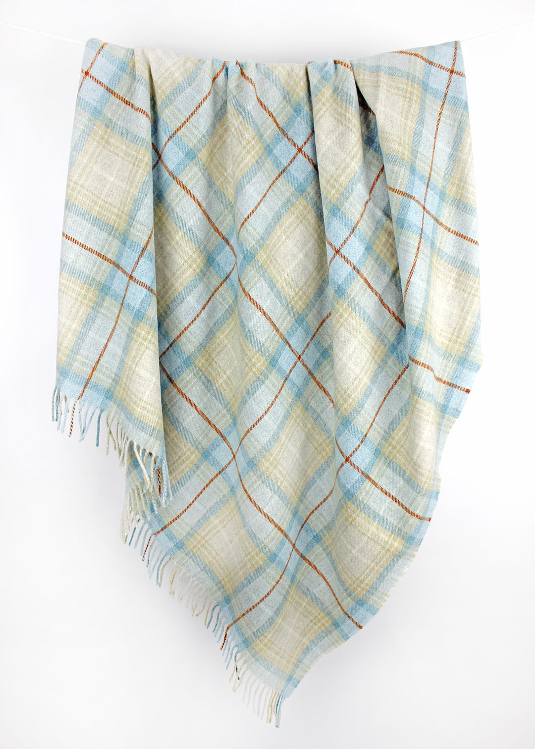 Plaid wool blanket with blue and beige colours on a white background.