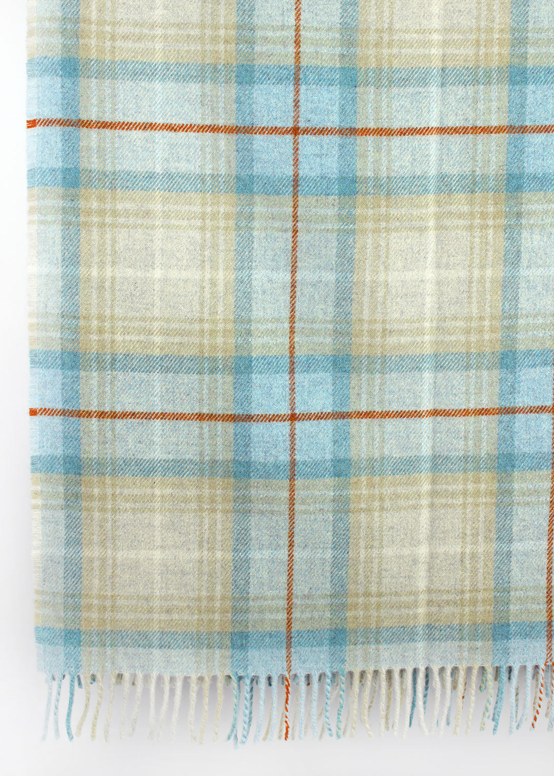 Plaid wool blanket with blue and beige colours on a white background.