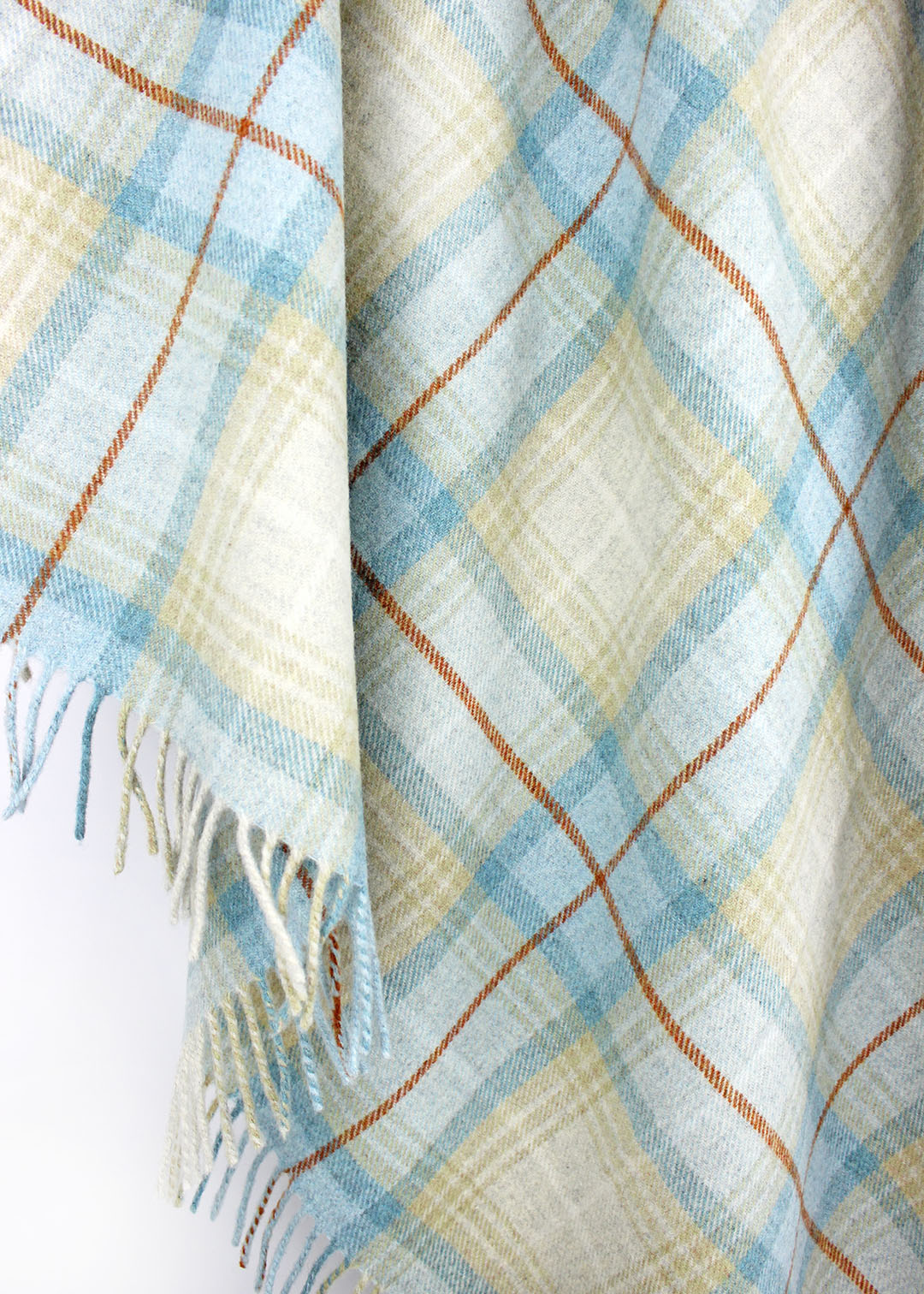 Plaid wool blanket with blue and beige colours on a white background.