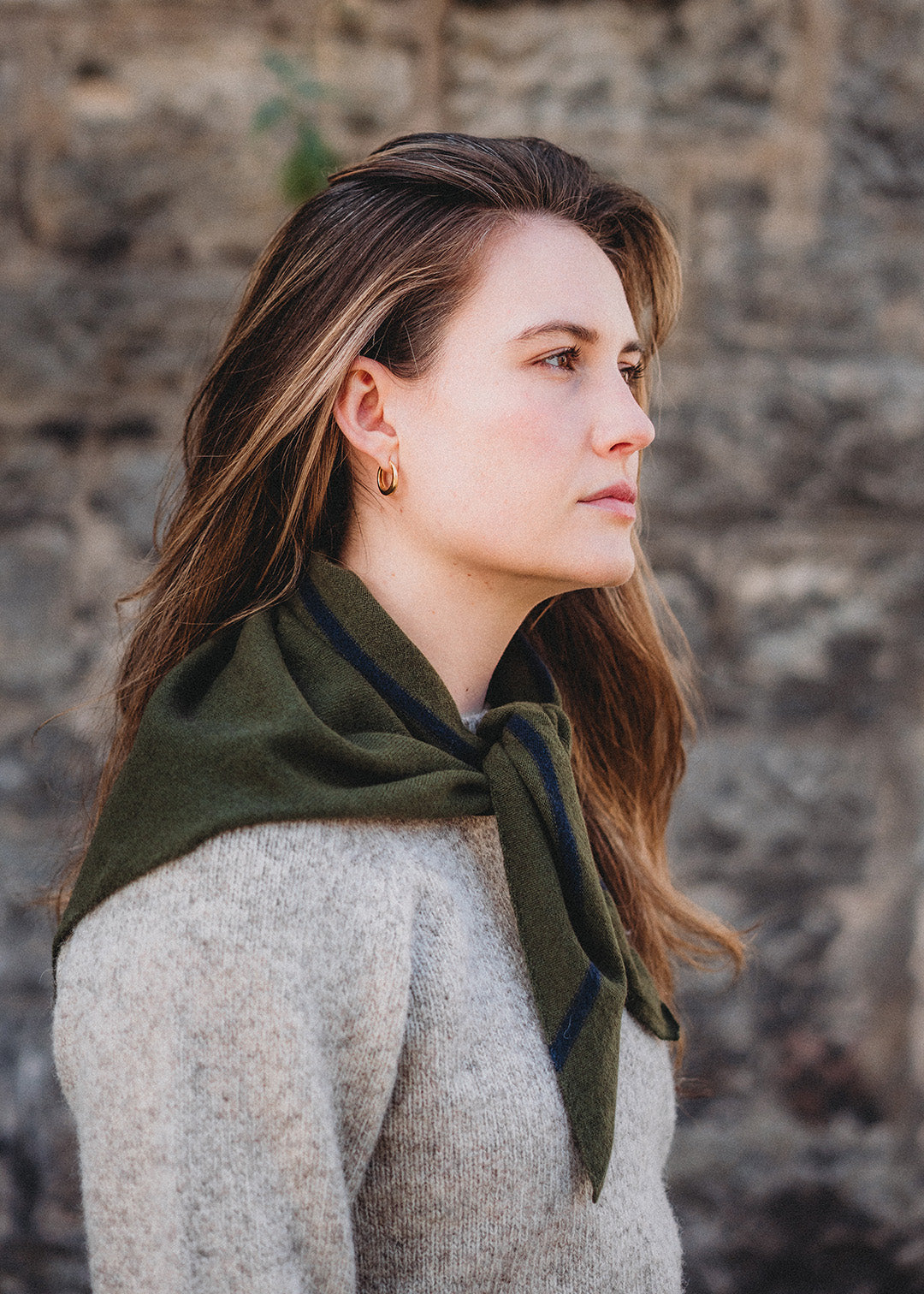 Knitted triangle scarf in dark loden green with a navy stripe.