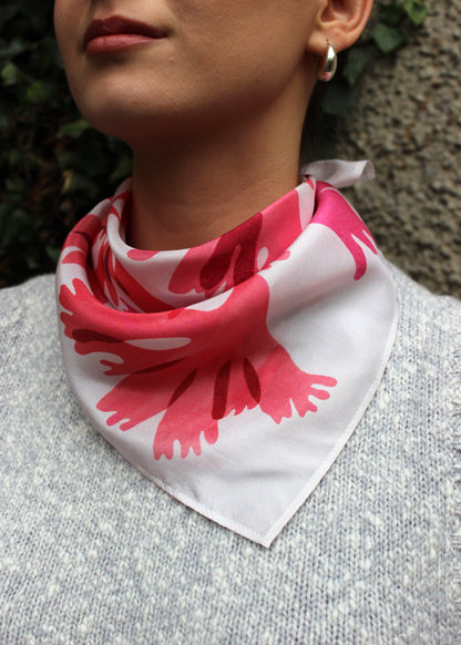 The Dulse silk scarf features a collaged print of dulse seaweed in vibrant pinks on a pearl white background.