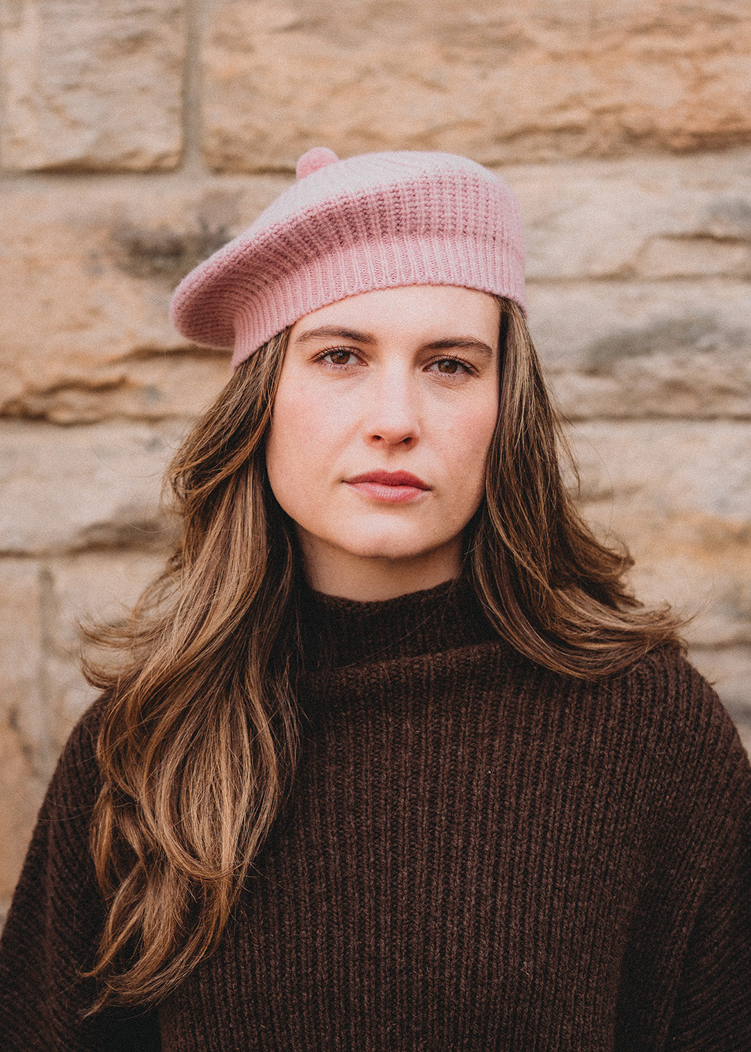 Lambswool beret in calamine pink, finished with a felted pom-pom on top.