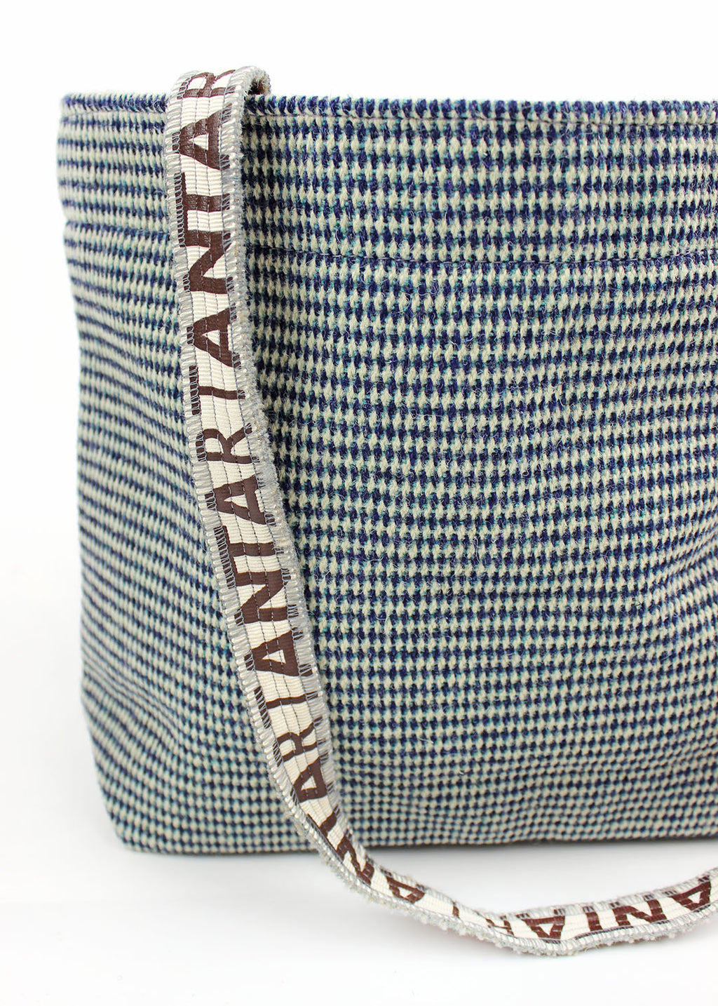 Wool carpet bag woven in teal blue and white.