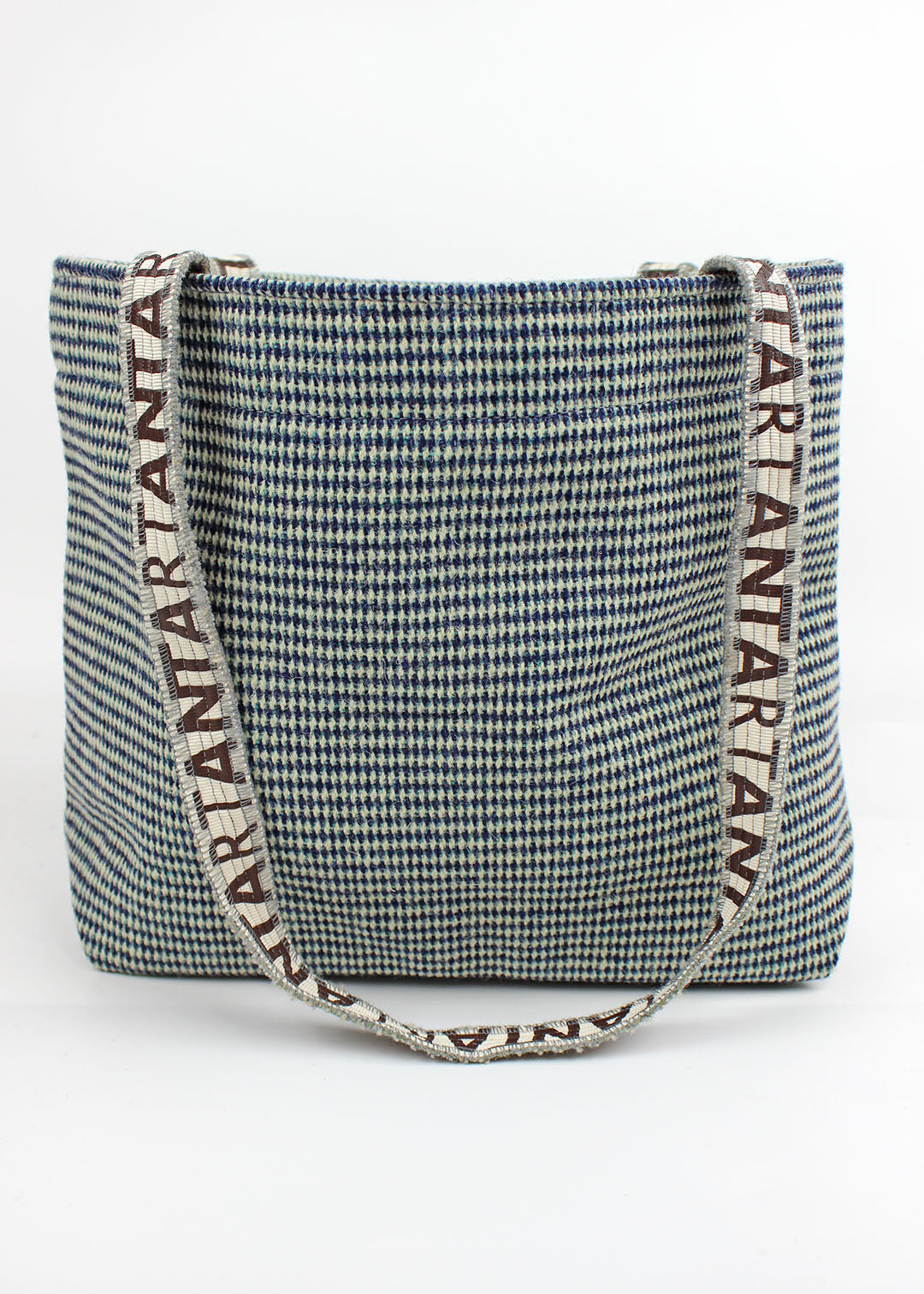 Wool carpet bag woven in teal blue and white.