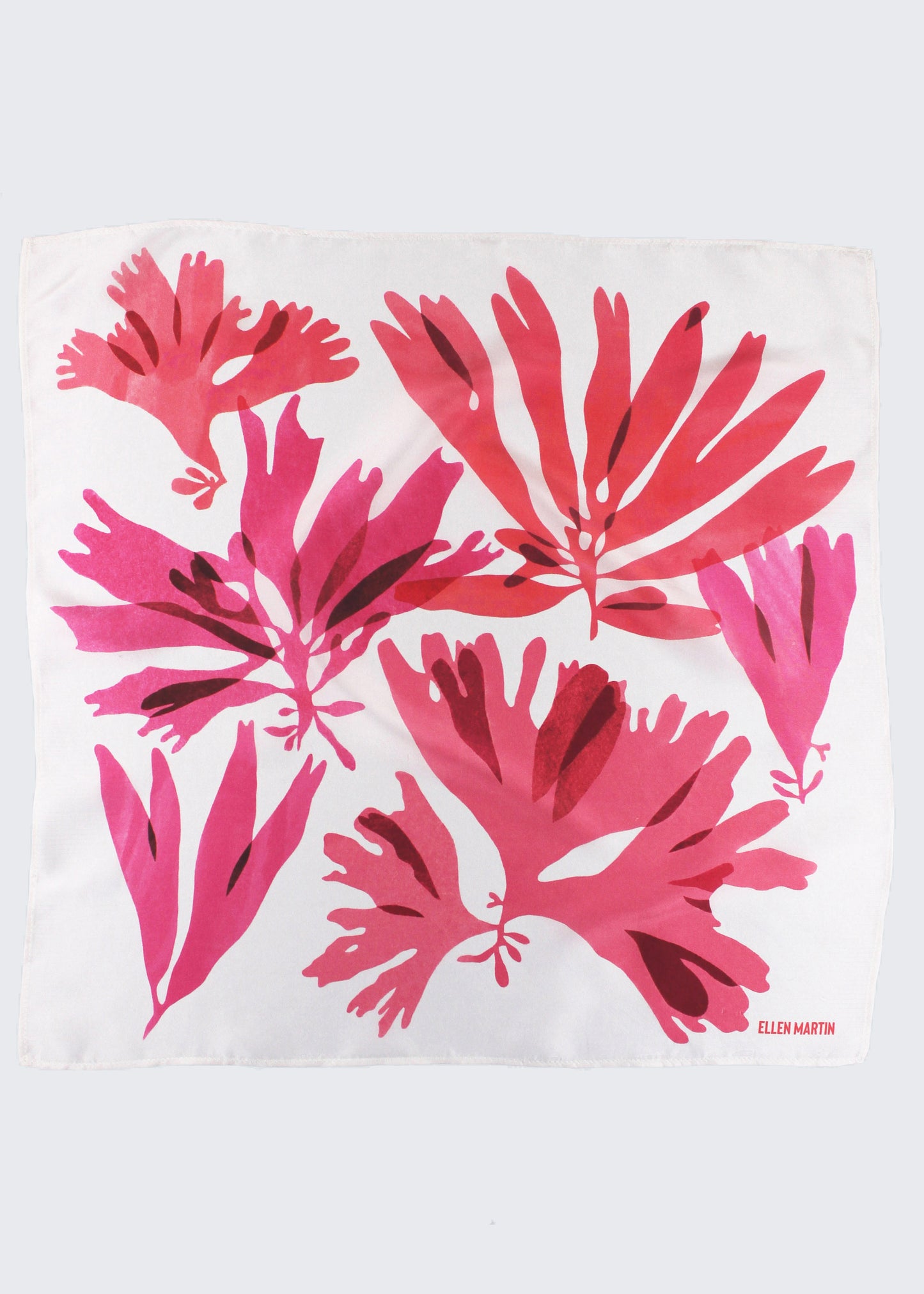 The Dulse silk scarf features a collaged print of dulse seaweed in vibrant pinks on a pearl white background.