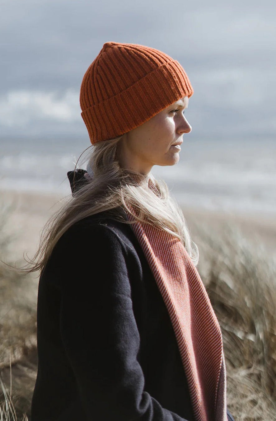 Ribbed knit beanie hat in deep orange Furnace colour. Scottish Textiles Showcase.