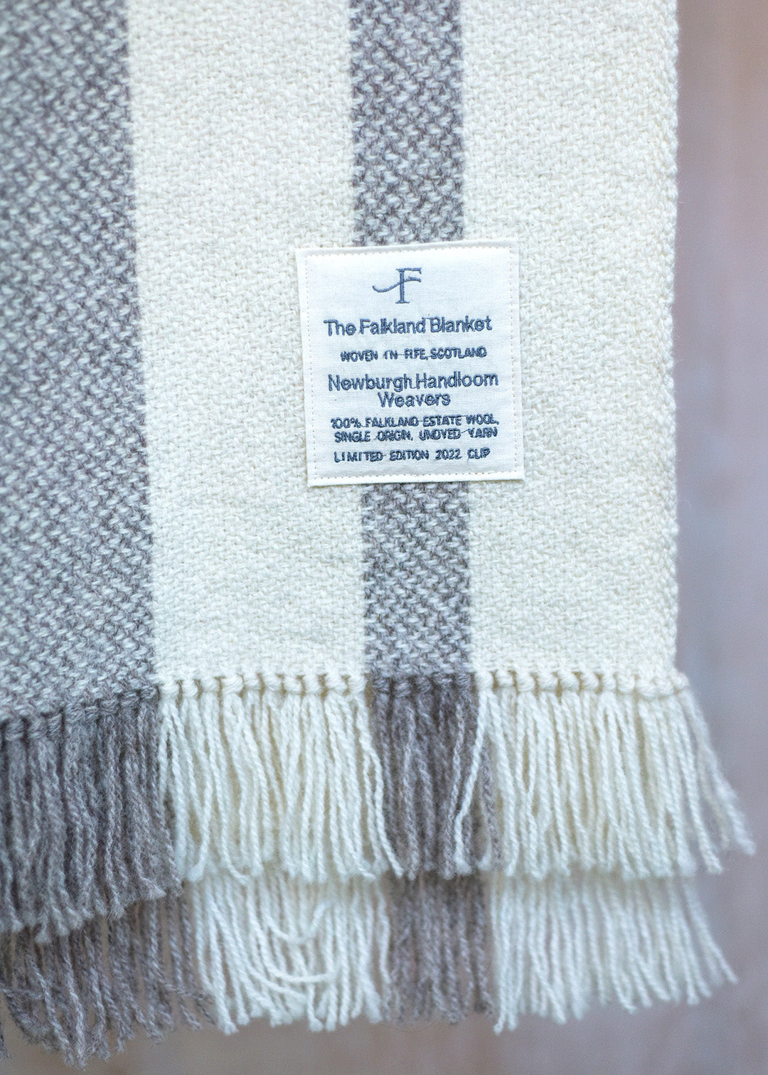 Handwoven Falkland Estate blanket in natural grey and off white.