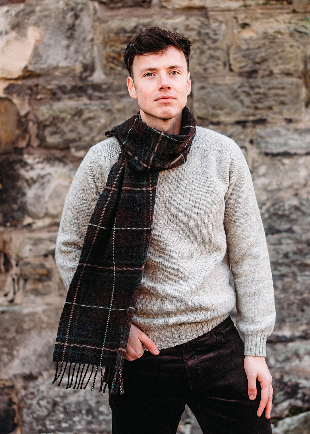 The Hebridean Glisk scarf is woven in soft, brushed lambswool with classic browns and greens.
