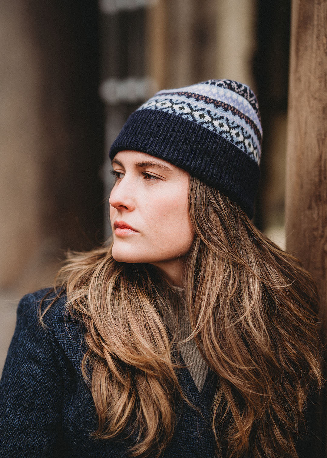 Knitted lambswool beanie in midnight blue with a playful Fair Isle pattern in pale blue, lilac and white.