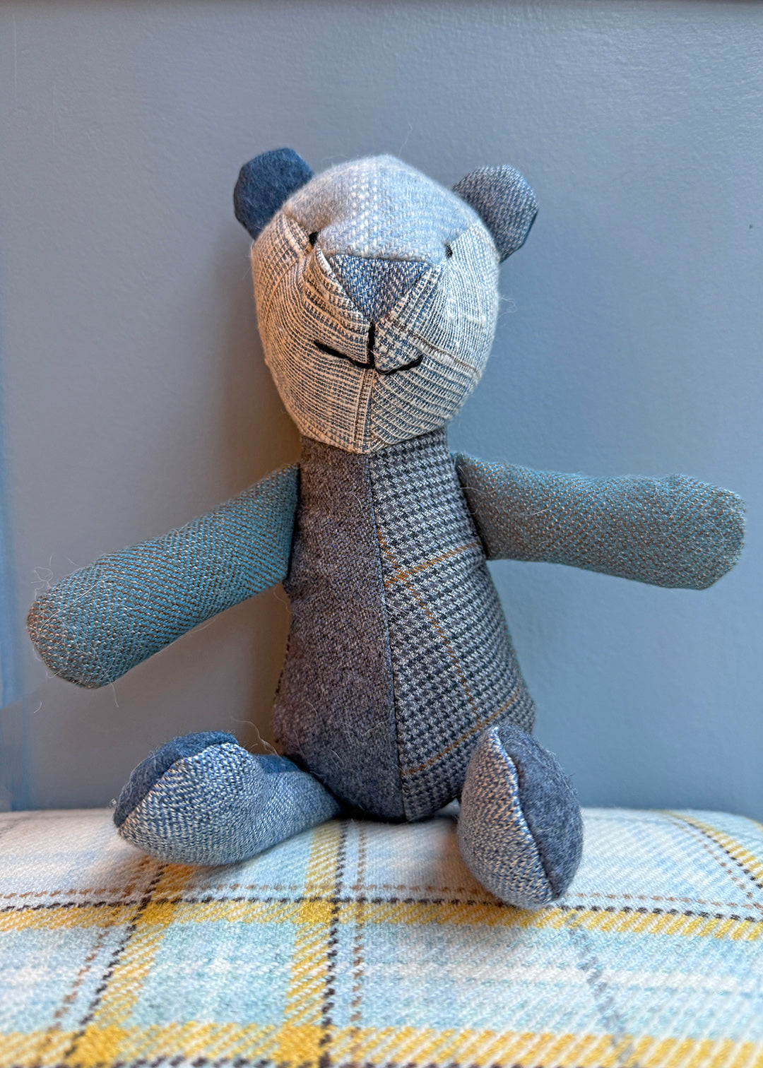 Unique patchwork tweed bear with different patterns and colours in shades of blue paired with natural tones.