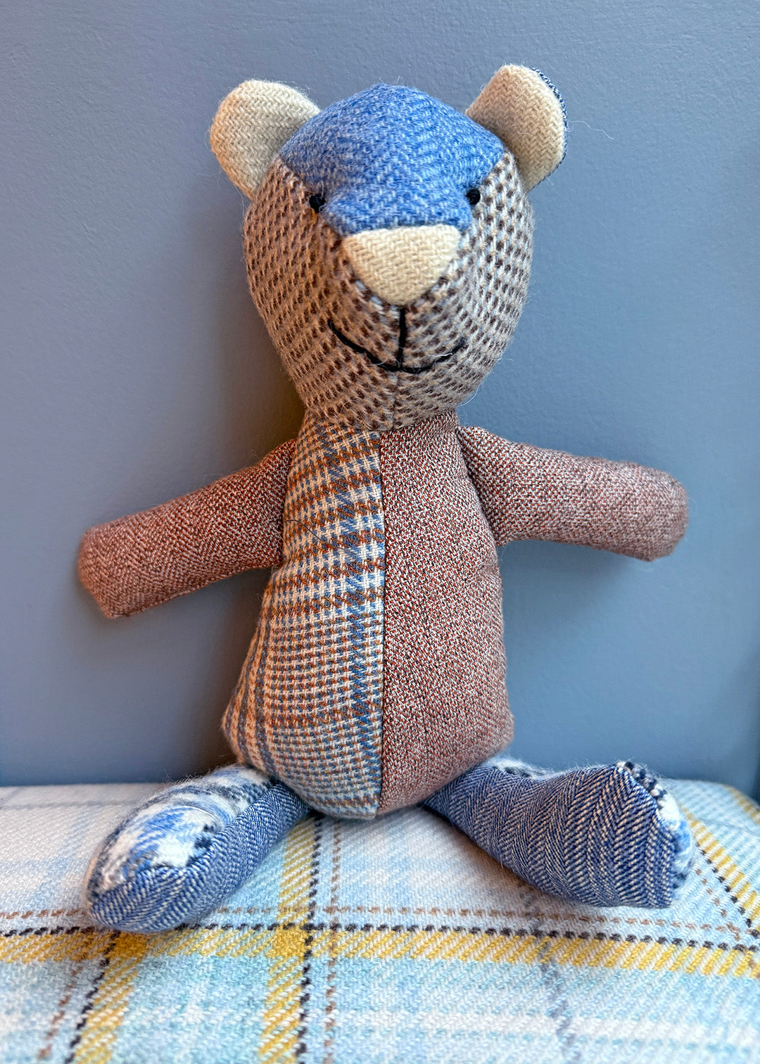 Unique patchwork tweed bear with different patterns and colours in shades of blue paired with natural tones.