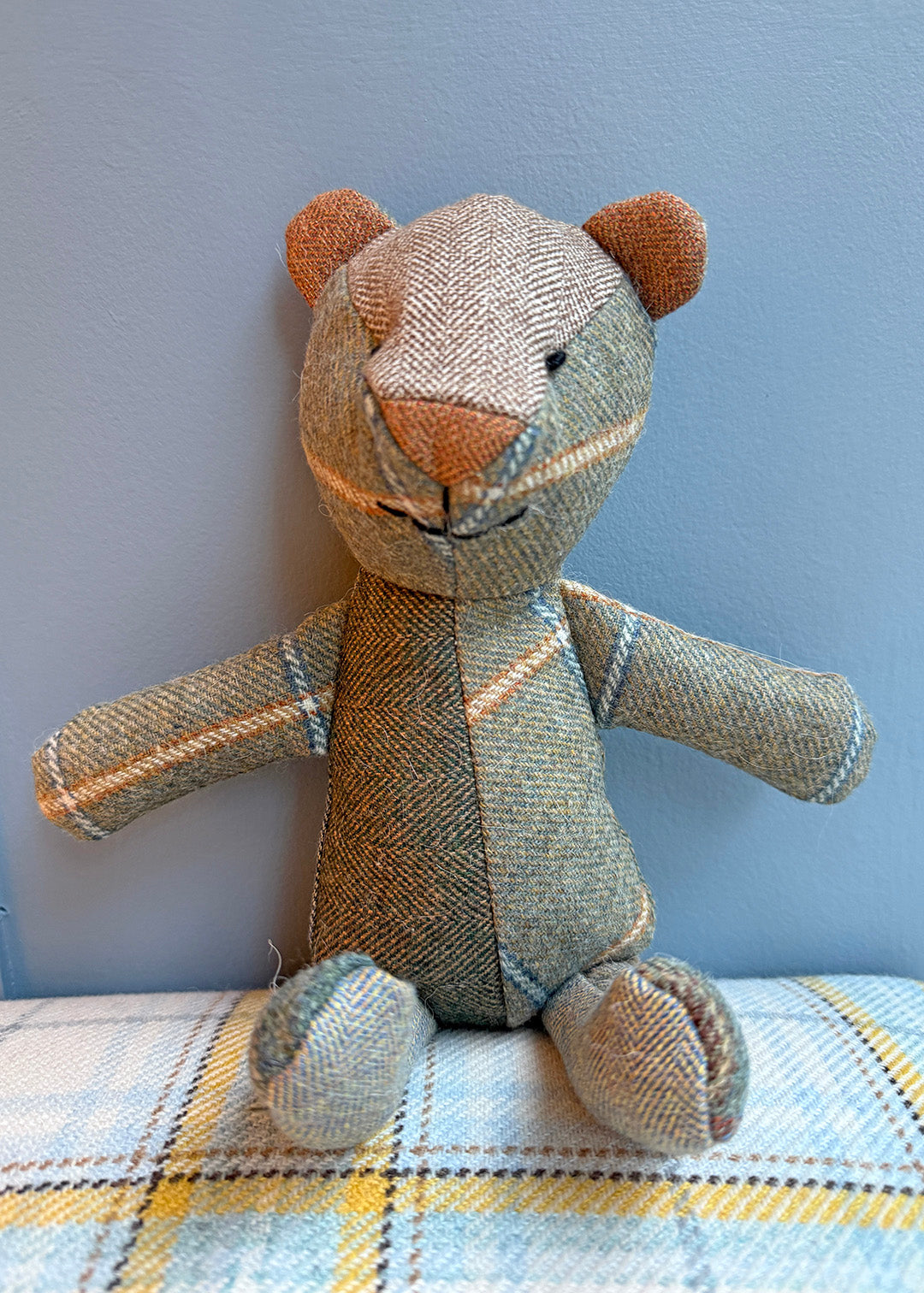 Unique patchwork tweed bear with different patterns and colours in shades of green tweed paired with natural tones.