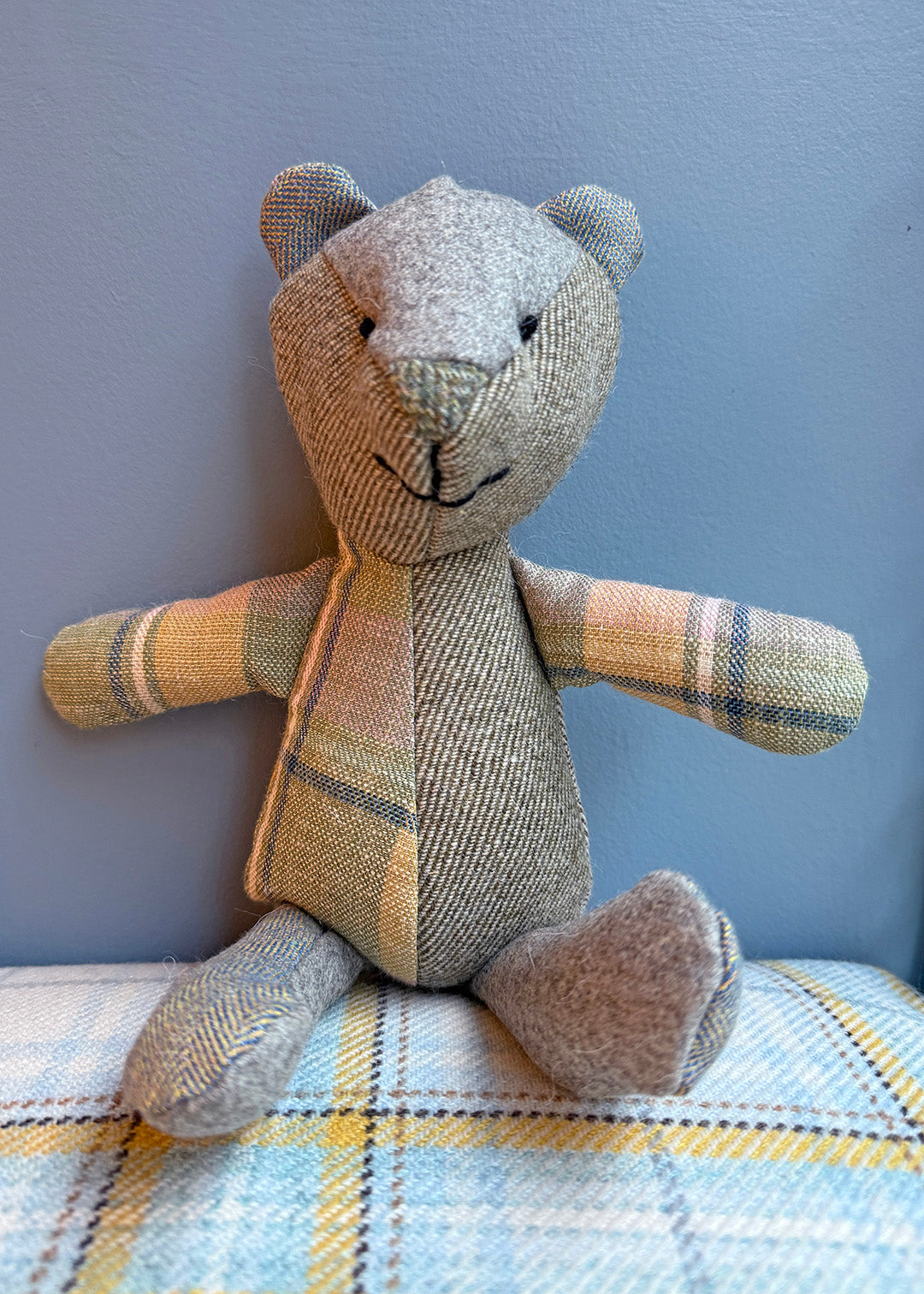 Unique patchwork tweed bear with different patterns and colours in shades of green tweed paired with natural tones.