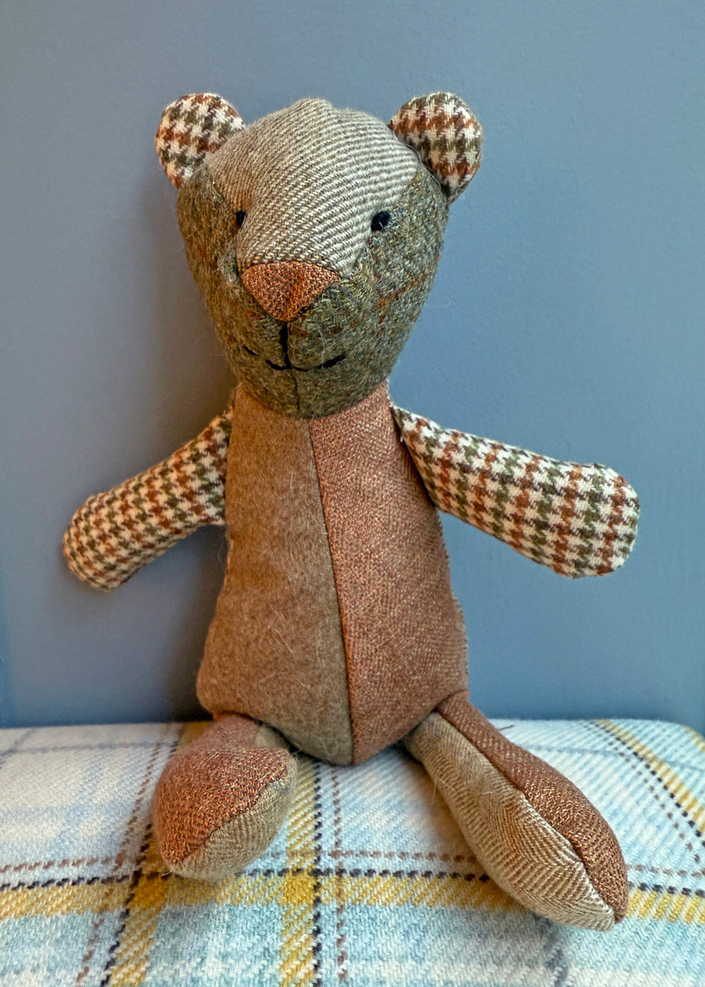 Unique patchwork tweed bear with different patterns and colours in shades of green tweed paired with natural tones.
