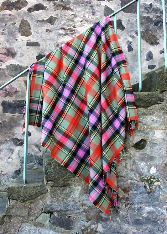 Lambswool tartan blanket woven in the vibrant greens, pinks and orange of the Bruce of Kinnaird tartan. Made in the Scottish Borders. Scottish Textiles Showcase.