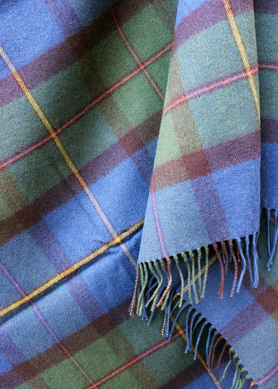 Lambswool tartan blanket in the blues, greens and browns of the Macleod of Harris tartan. Made in the Scottish Borders. Scottish Textiles Showcase.