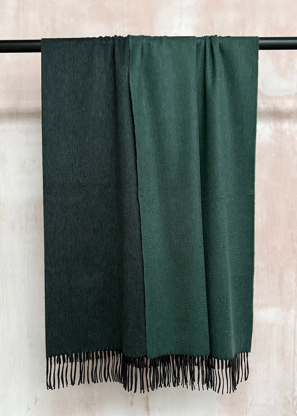 Luxurious cashmere throw woven in a striking blend of deep teal tones.