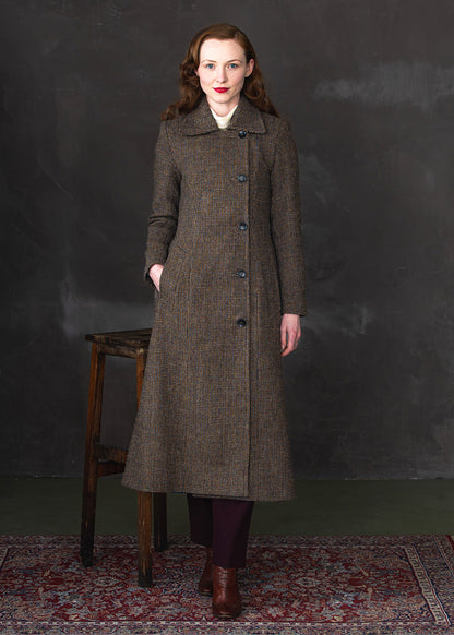 Maxi length Harris Tweed coat featuring offset buttons and a contrasting blue satin lining.