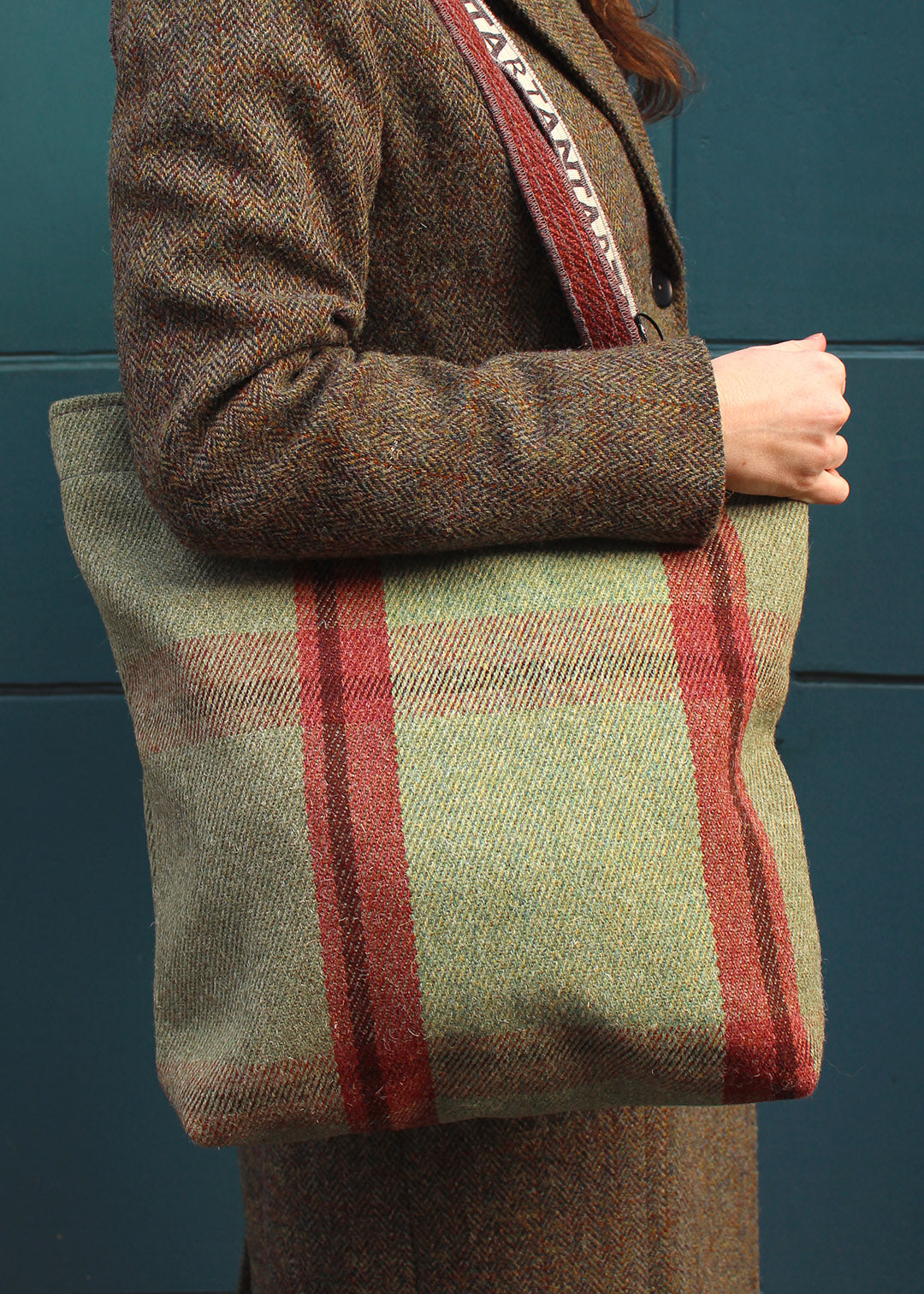 The Moniak bag is woven in an oversized check in sage green and rusty red.