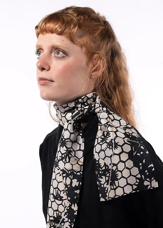The Mono skinny silk scarf has been digitally printed with a repeat pattern in off-white and navy-black.