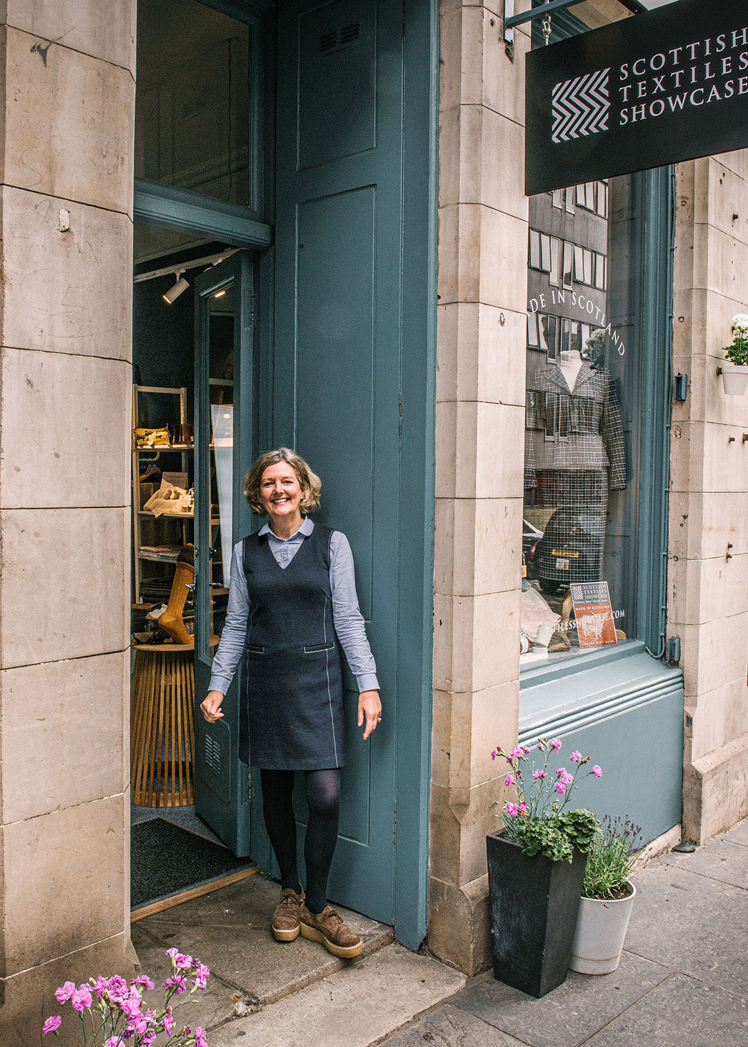 Kitty standing in front of the Scottish Textiles Showcase shop