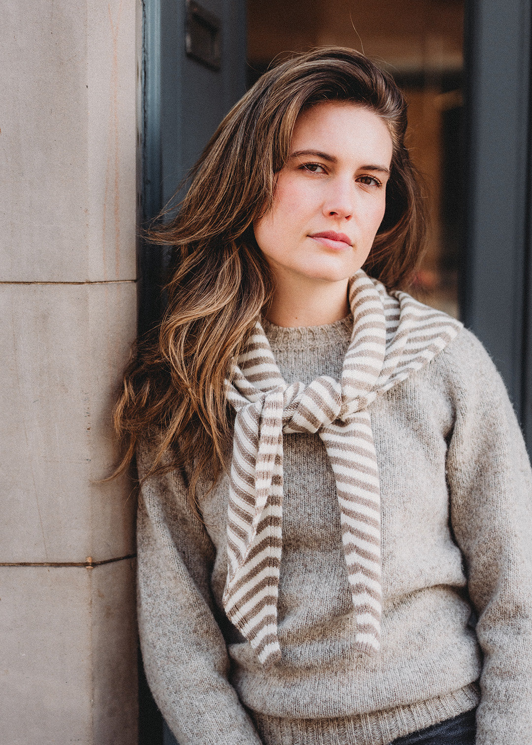 Triangle scarf knitted in soft lambswool in an oat and off-white stripe.