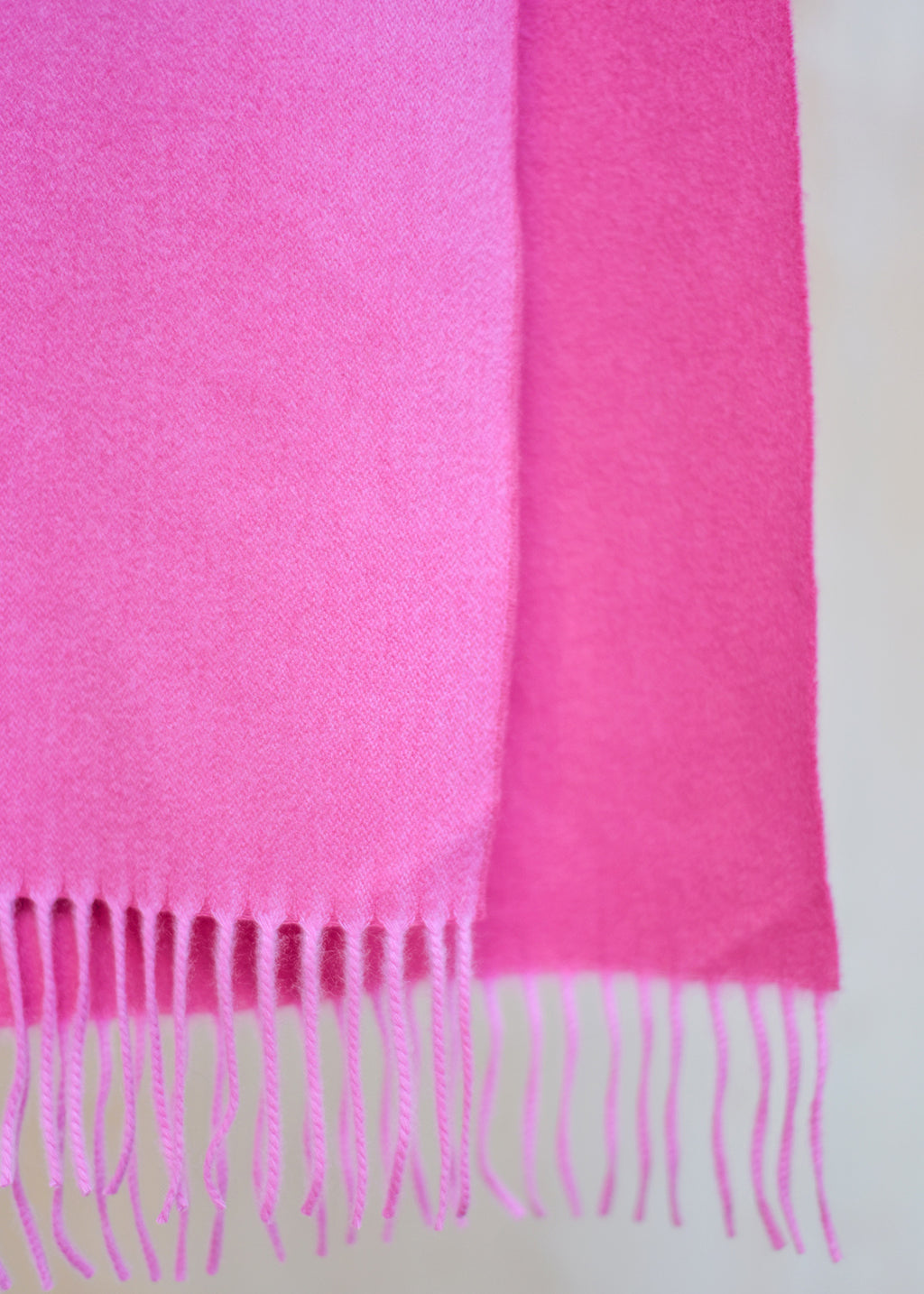 Beautifully soft, reversible cashmere scarf in two shades of bubblegum pink.