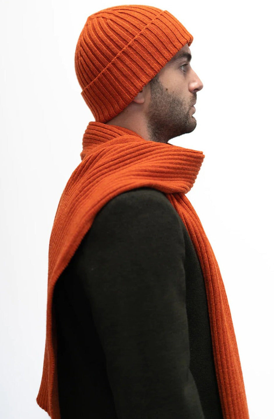 Jacquard ribbed scarf knitted in Ayrshire in sumptuously soft lambswool by Hilary Jane Keyes. In shade Furnace - deep orange