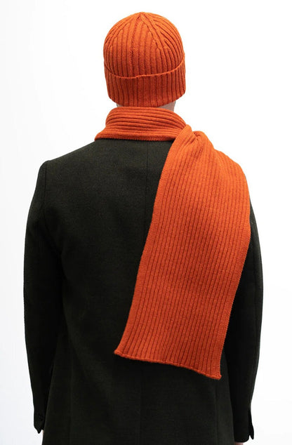 Jacquard ribbed scarf knitted in Ayrshire in sumptuously soft lambswool by Hilary Jane Keyes. In shade Furnace - deep orange