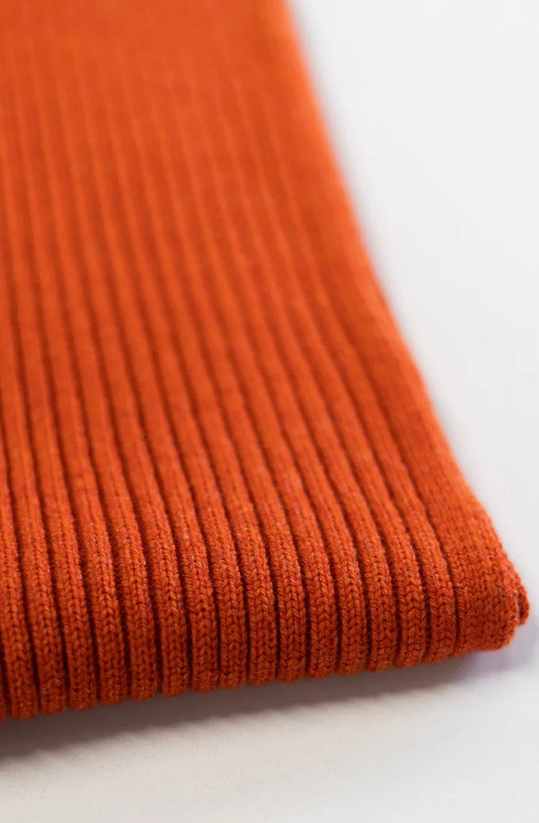 Jacquard ribbed scarf knitted in Ayrshire in sumptuously soft lambswool by Hilary Jane Keyes. In shade Furnace - deep orange