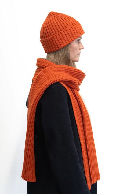 Jacquard ribbed scarf knitted in Ayrshire in sumptuously soft lambswool by Hilary Jane Keyes. In shade Furnace - deep orange