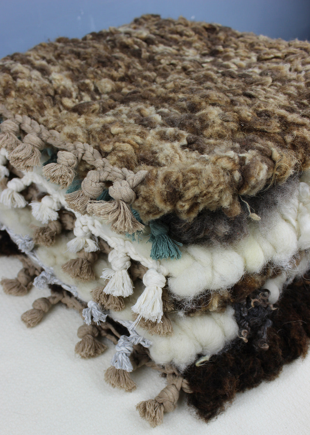 Hand woven sheep fleece rugs in a range of natural colours.