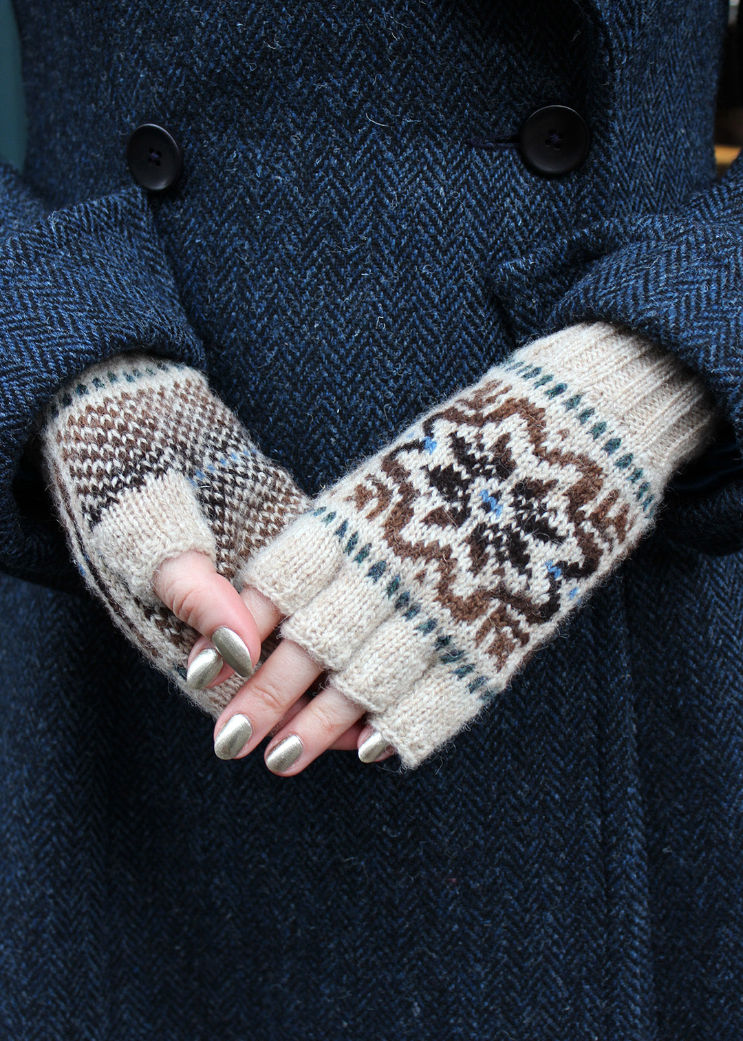 Hand knitted Fair Isle fingerless gloves in beige with contrasting details.