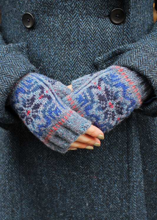 Hand knitted Fair Isle fingerless gloves in shades of blue.