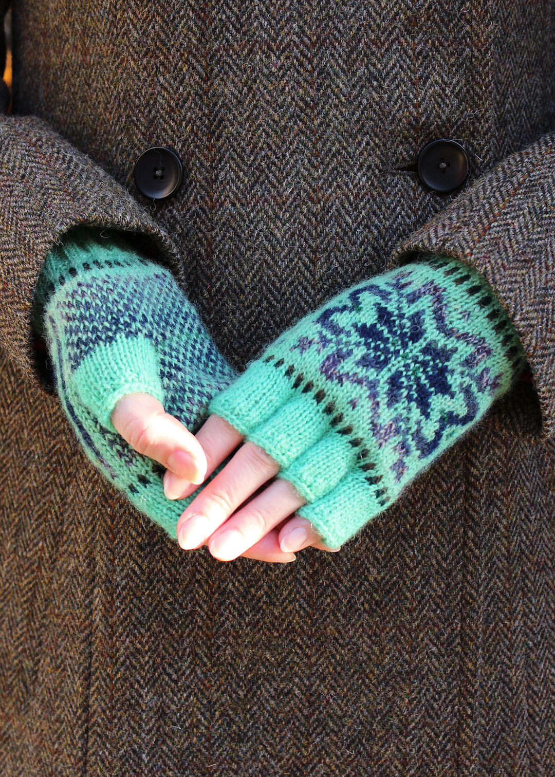 Hand knitted gloves in mint green with Fair Isle pattern.